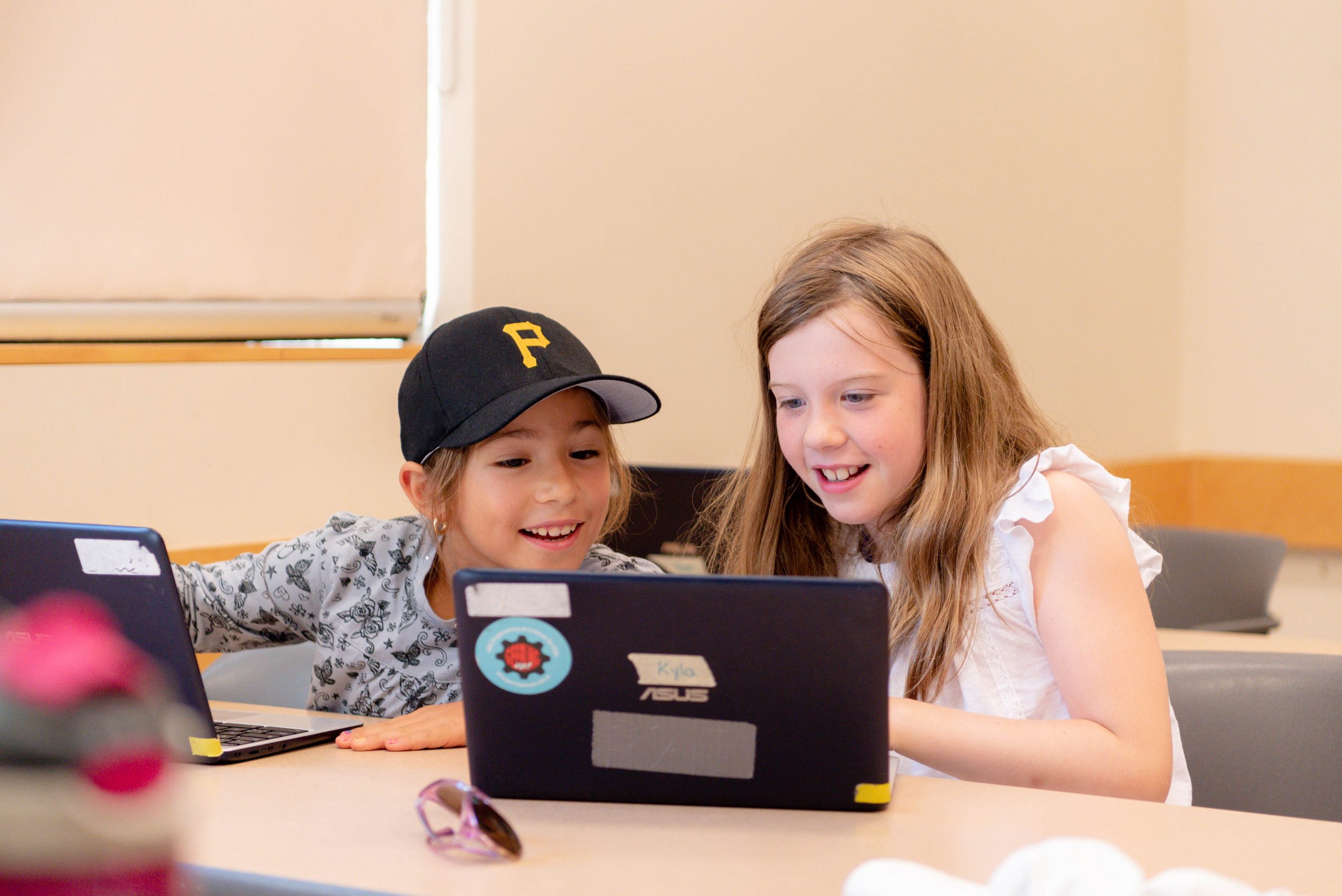 two children looking at a computer