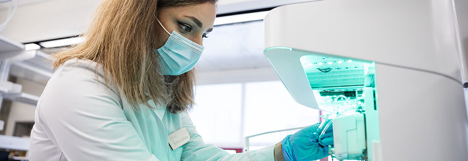 Researcher in a lab using a machine