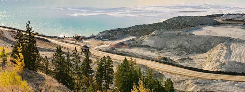 Mining site with sparkling blue water in the background