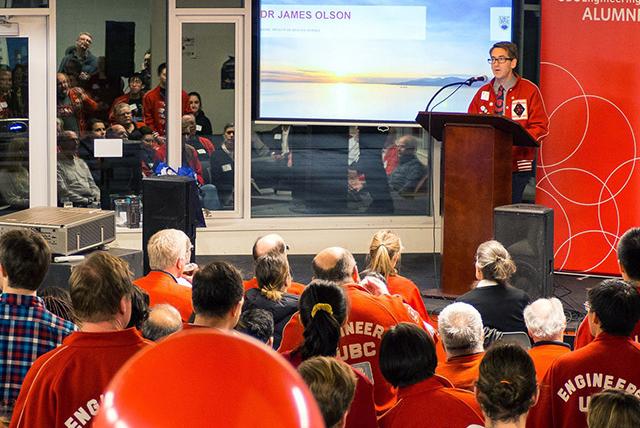 Engineering Alumni event with many people in red listening to a speaker.