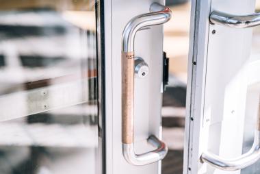 A door handle wrapped in a copper coating