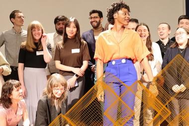 Students posing triumphantly on a stage