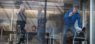 People drawing on a white board