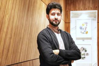 ECE PHD Student Mohammad Jafari poses for the camera with arms crossed